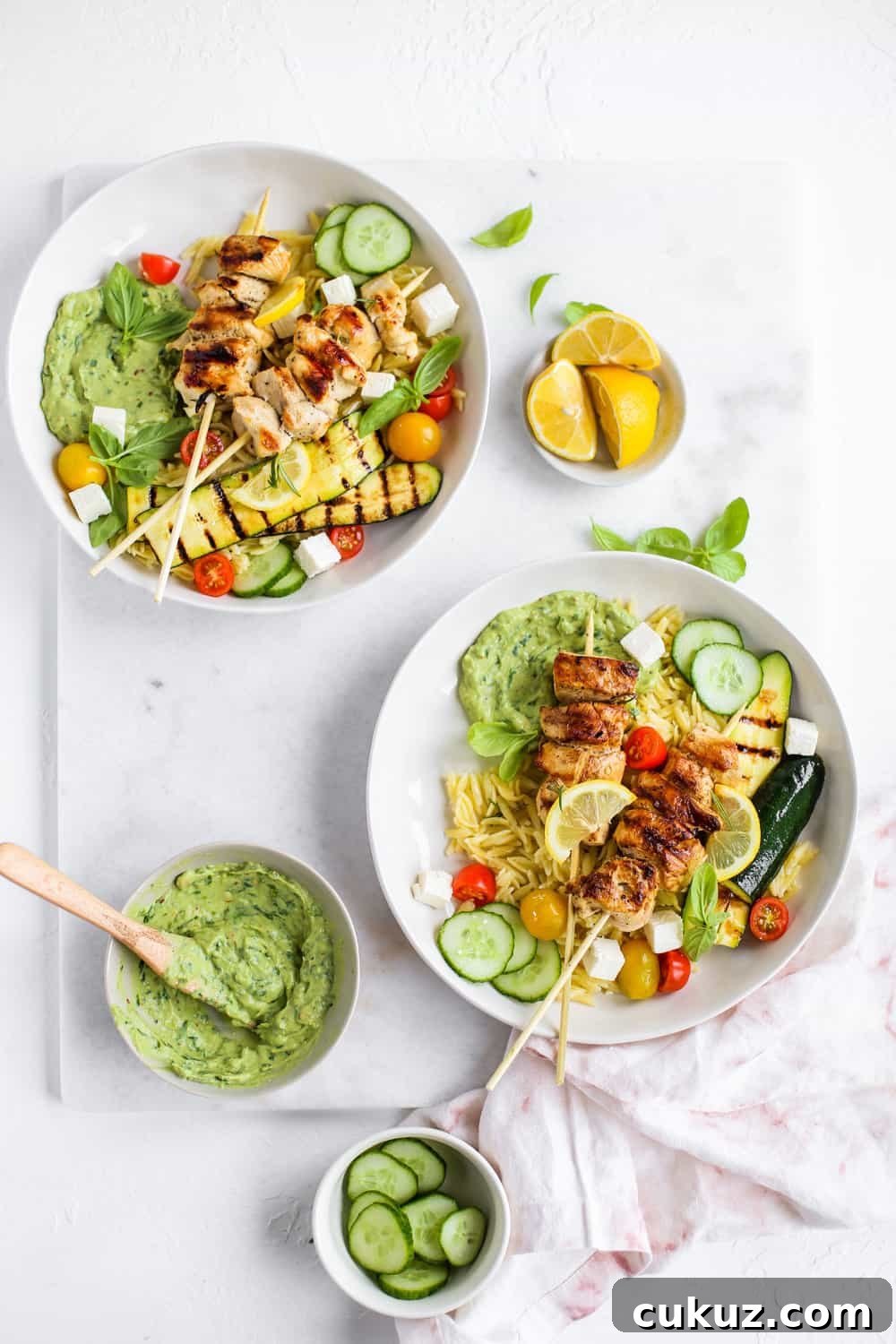 Lemon Garlic Chicken Skewer Bowls with orzo and green goddess dressing in a white bowl