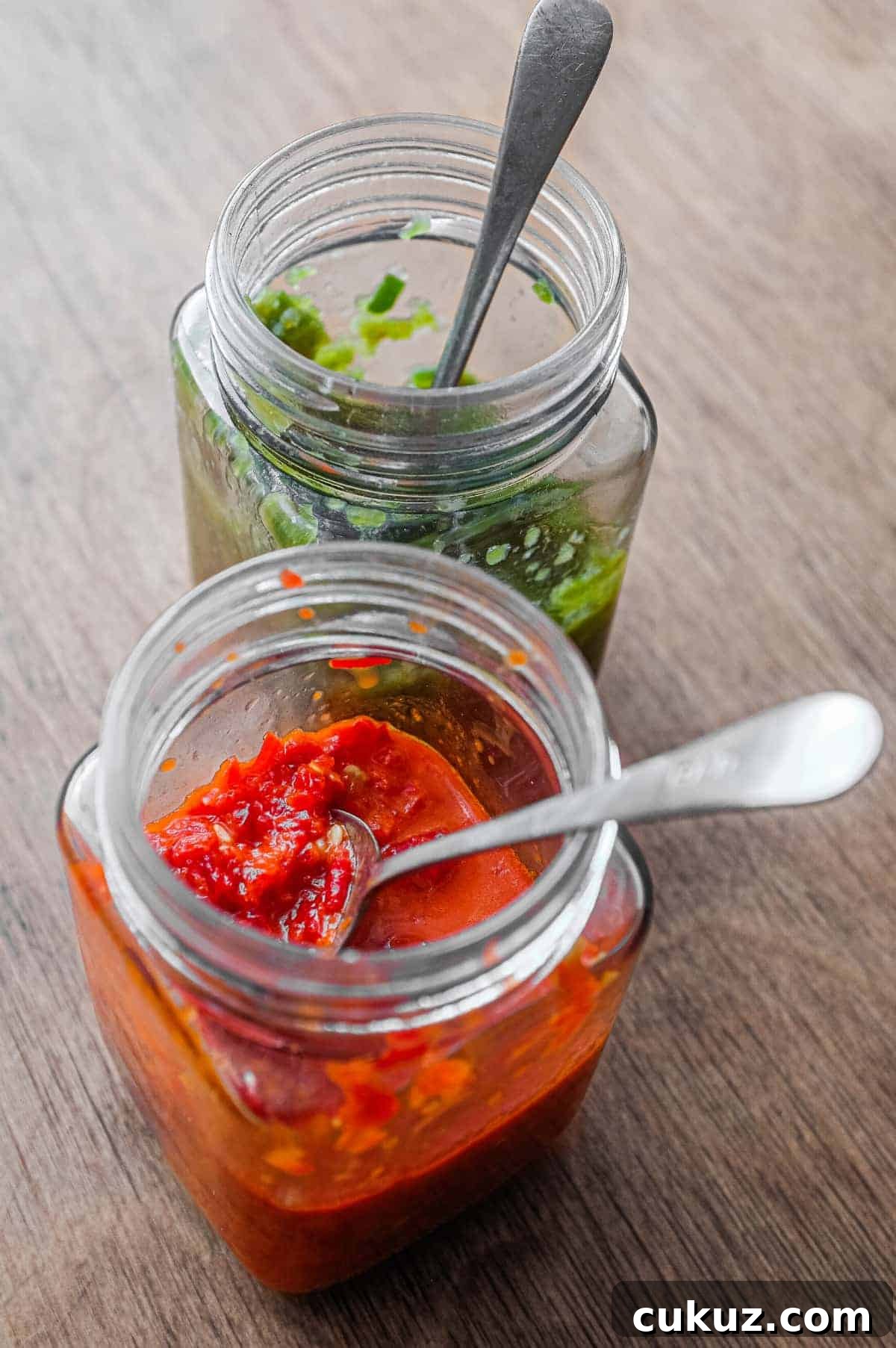 Two jars of Middle Eastern Shatta Sauce. A red variety and green variety.