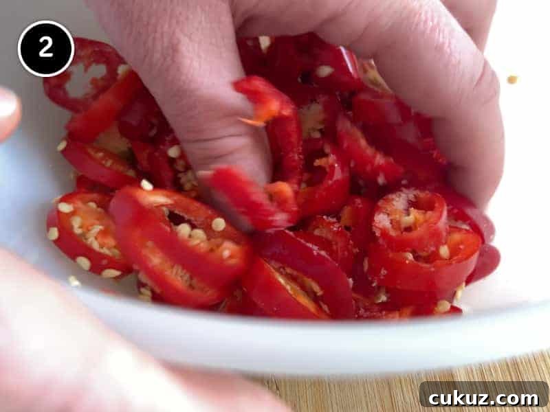 Mixing red chillies by hand in a bowl
