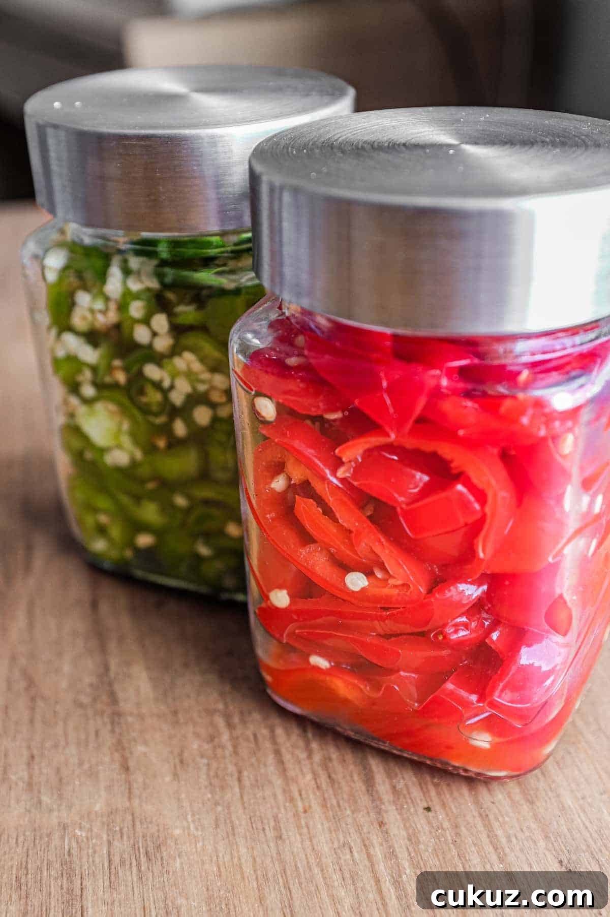 Two bowls of chillies ready for fermentation. A red variety and green variety.