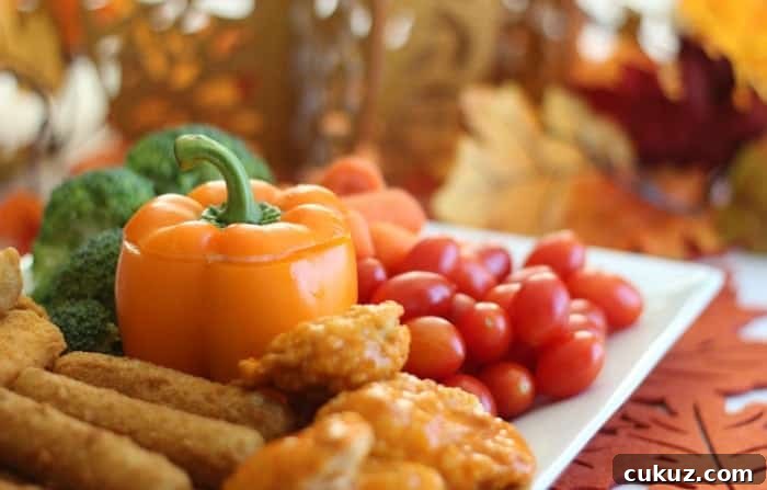 platter of appetizers with orange bell pepper in center