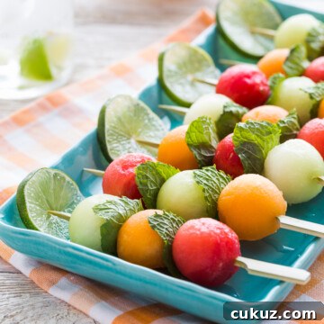 Fruit kabobs with watermelon, cantaloupe, and honeydew melons.