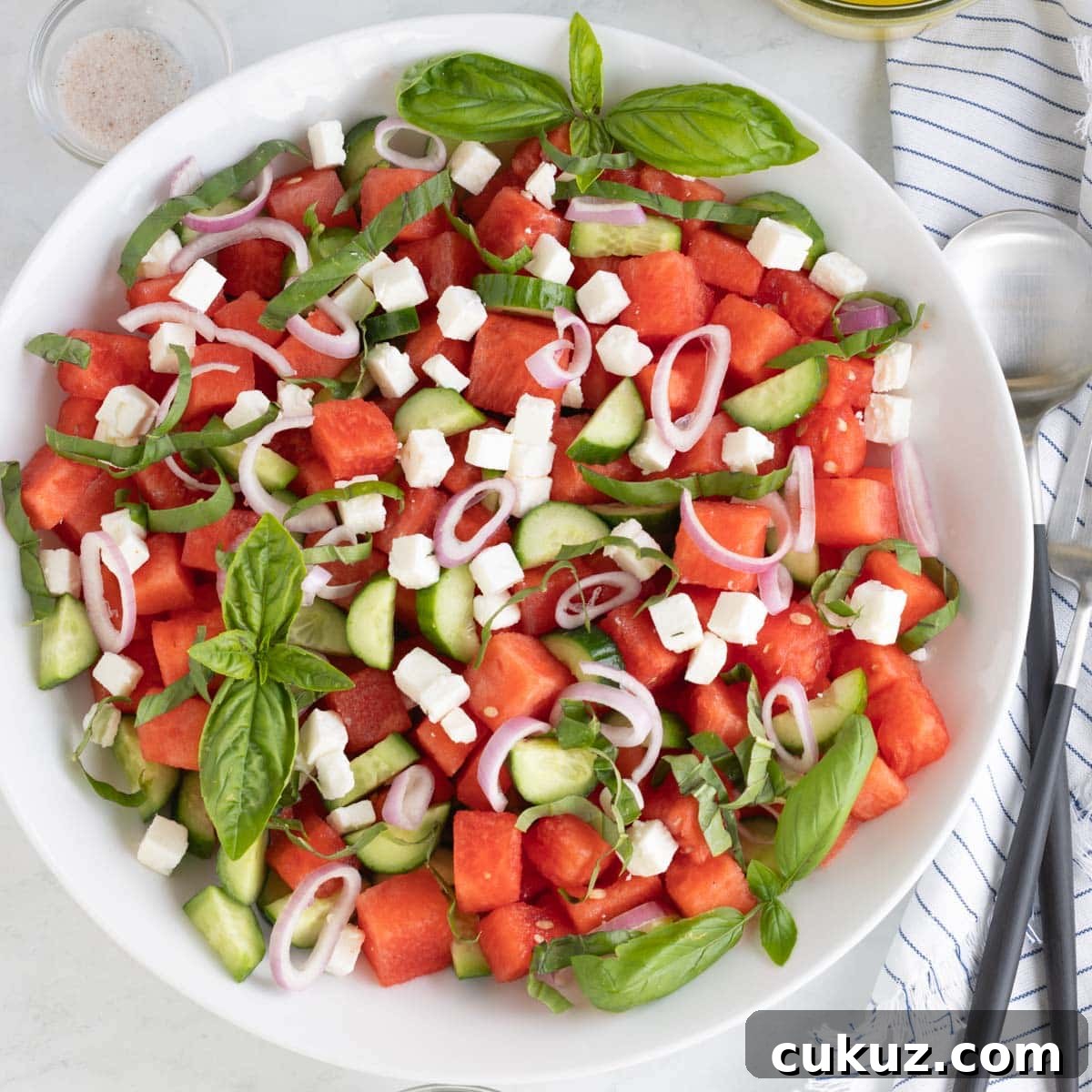 Watermelon salad ready to serve with cucumber, feta, basil, shallots.