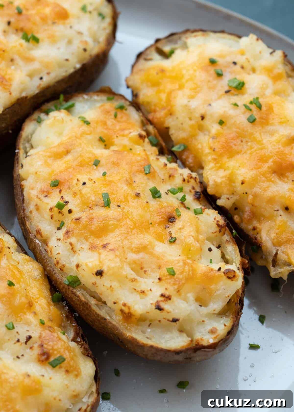 These Air Fryer Twice Baked Potatoes are the perfect side dish or appetizer! Get that cheesy center and ultra-crispy potato skin quickly with this easy recipe.