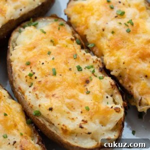 These Air Fryer Twice Baked Potatoes are the perfect side dish or appetizer! Get that cheesy center and ultra-crispy potato skin quickly with this easy recipe.