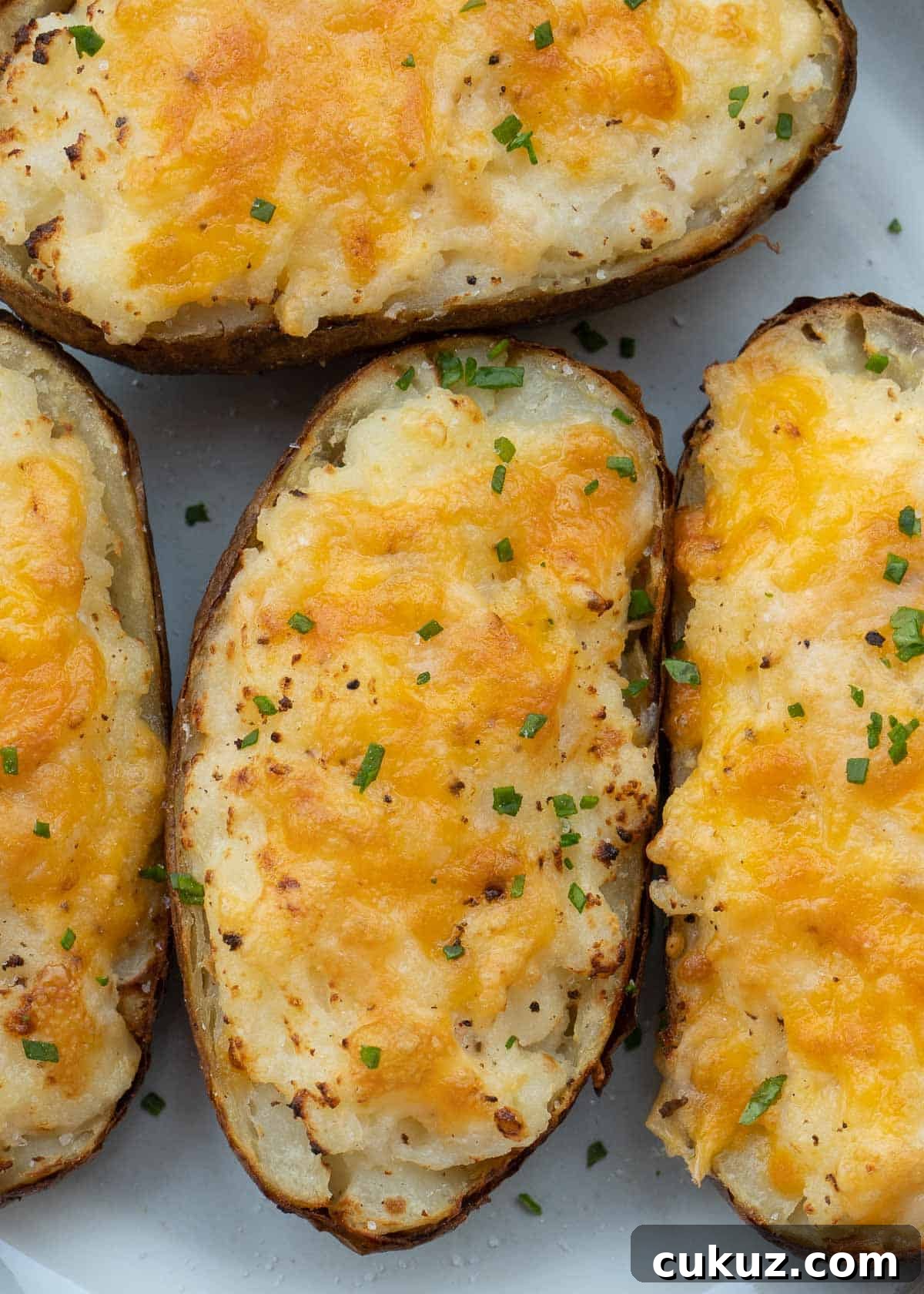 These Air Fryer Twice Baked Potatoes are the perfect side dish or appetizer! Get that cheesy center and ultra-crispy potato skin quickly with this easy recipe.