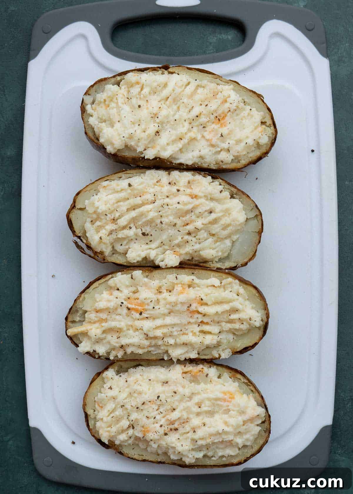 scoop the creamy, well-mixed filling into the hollowed potato skins
