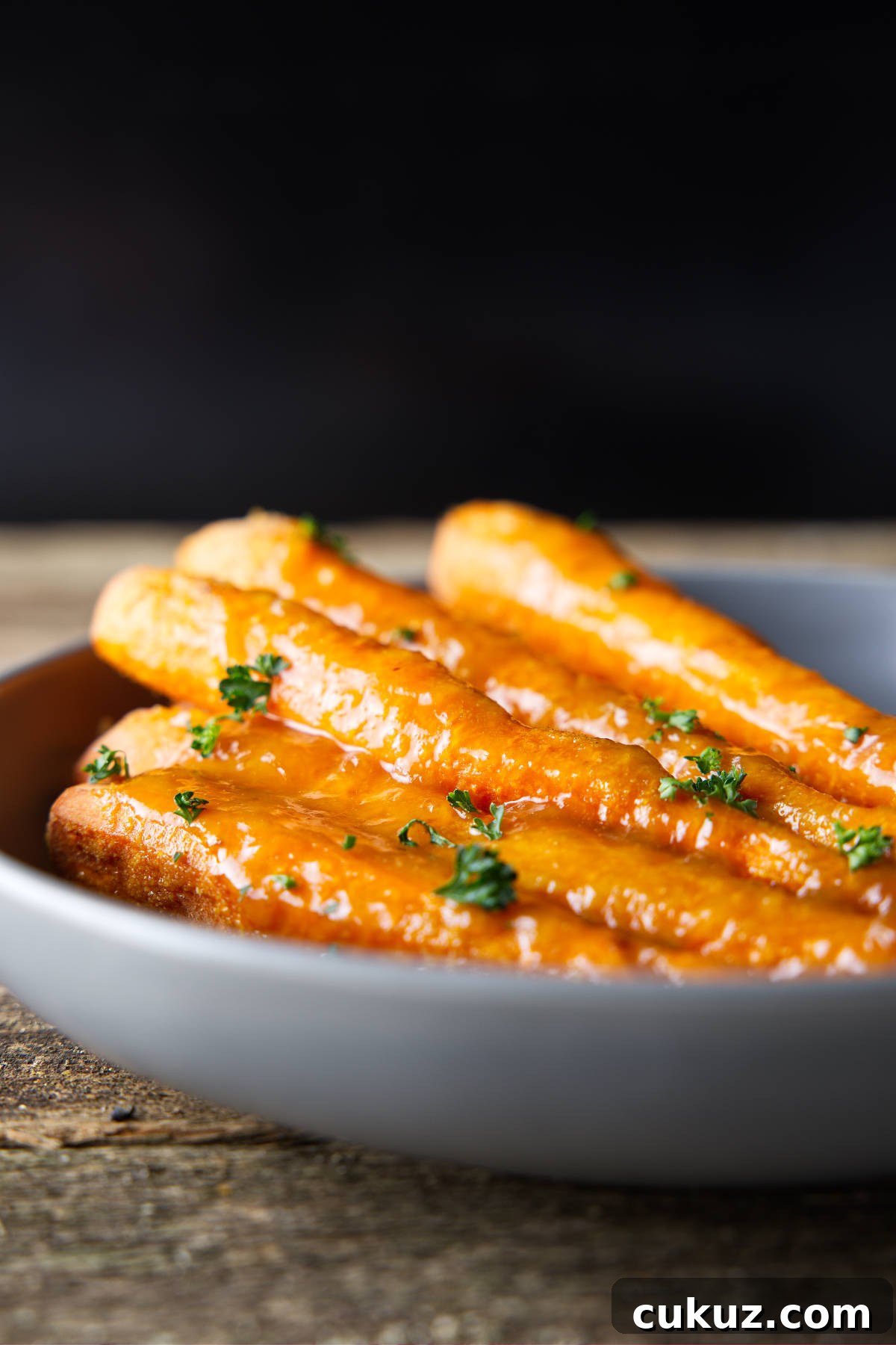 Glazed smoked carrots in a bowl.
