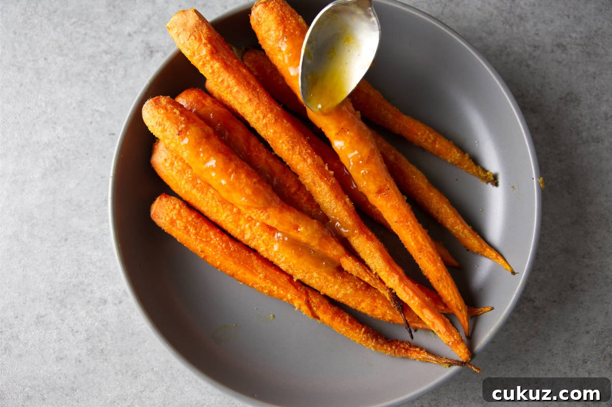 Drizzling a glaze over smoked carrots.