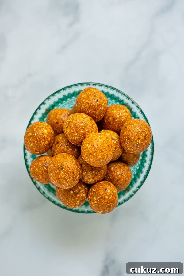 overhead shot of orange energy bites in a teal bowl