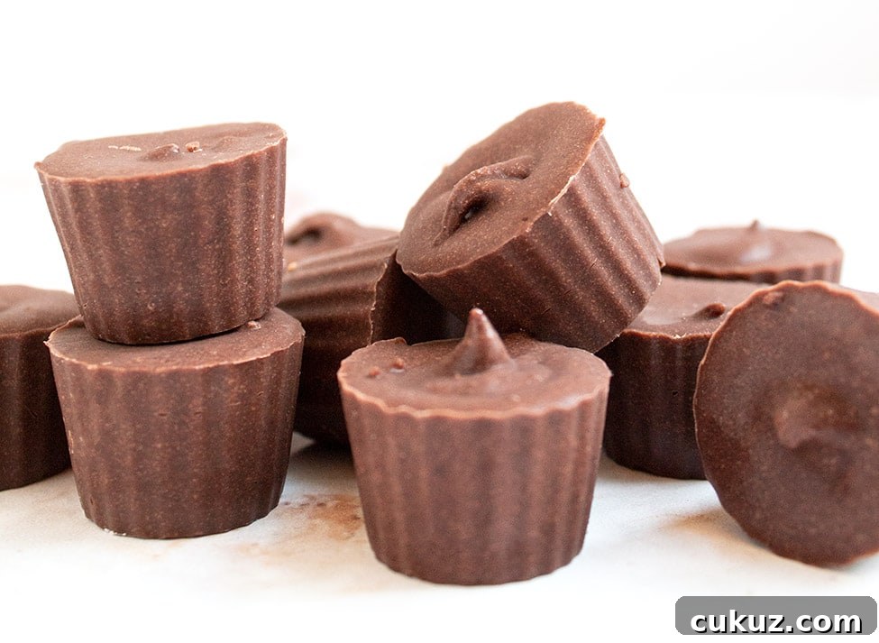 chocolate fat bombs stacked up on top of each other with white background