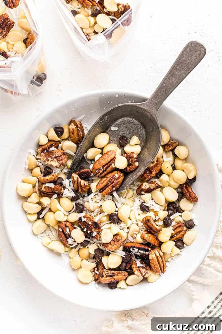 overhead view of keto trail mix in a white bowl with a spoon