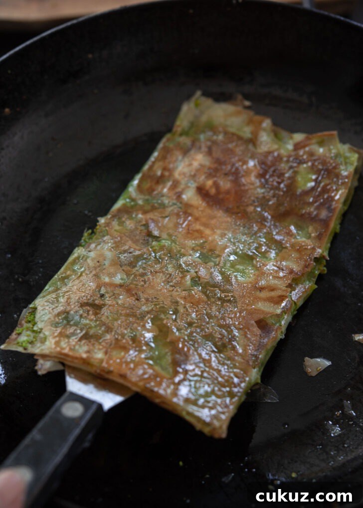 Turkish Katmer pan-fried to golden brown on the surface.