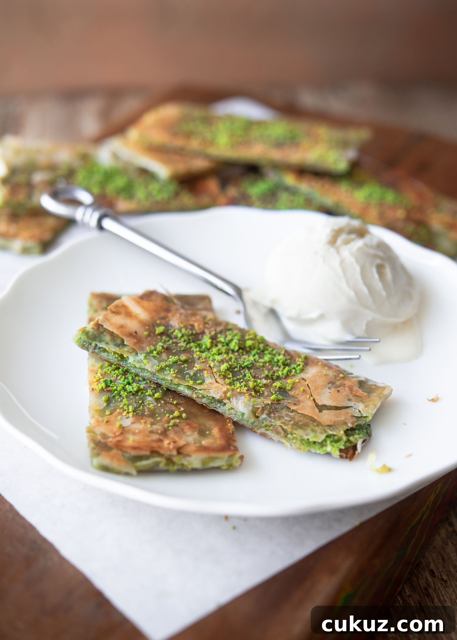 Sliced Katmer served with vanilla ice cream.