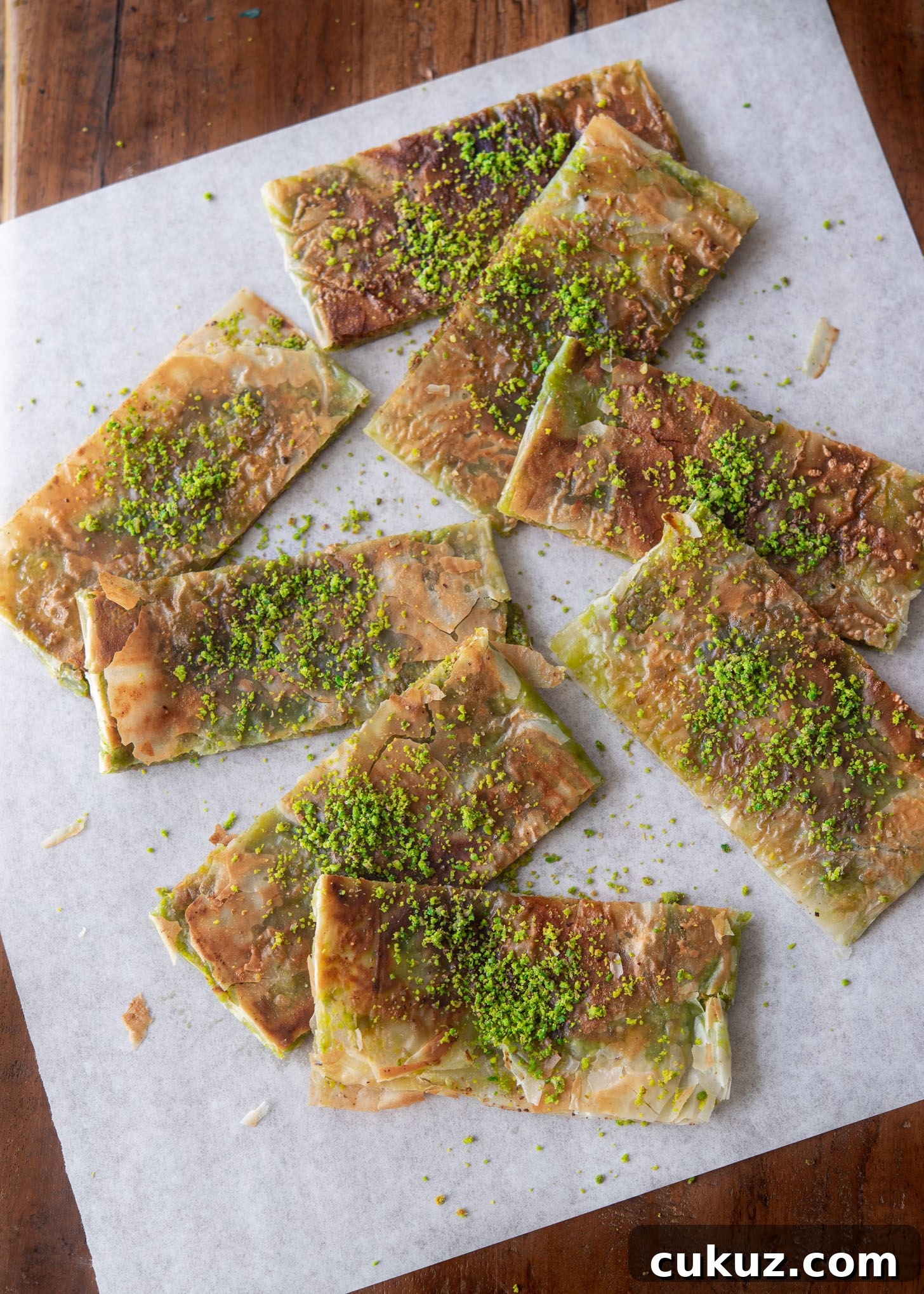 Turkish pistachio dessert slices garnished with ground pistachio nut.