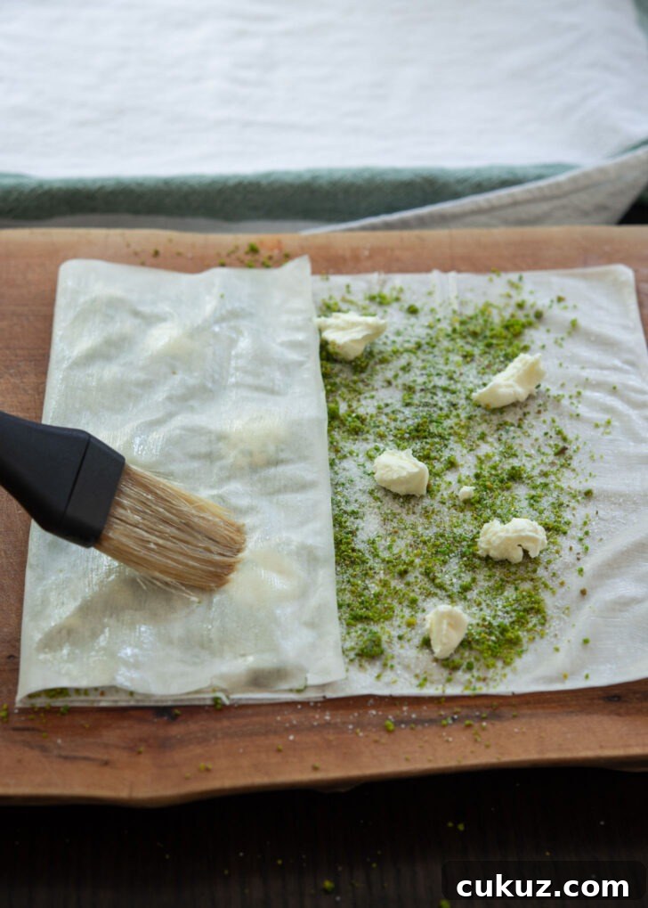 One side of Filo sheet folded over pistachio and clotted cream filling.