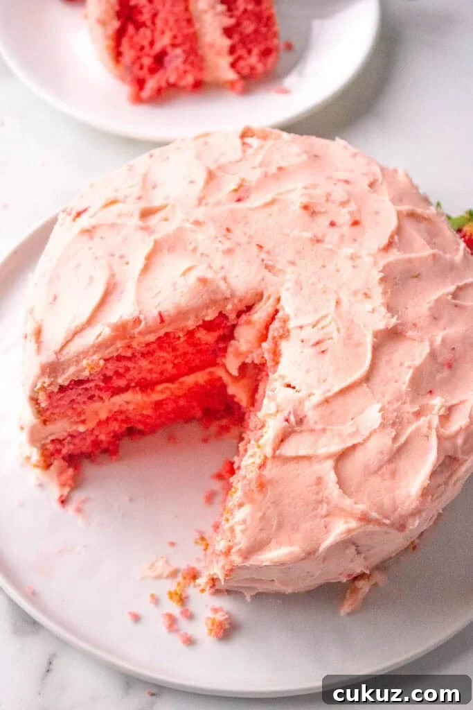 strawberry layer cake on a white plate 