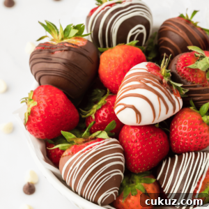 a bowl full of chocolate covered strawberries mixed with fresh, whole strawberries