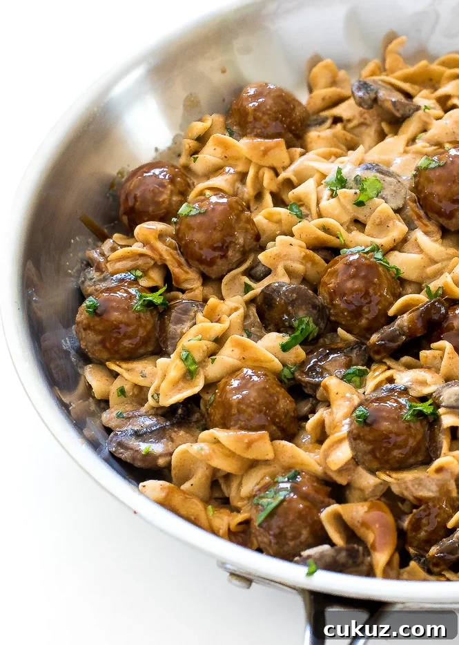 Egg noodles and meatballs smothered in delicious stroganoff sauce in a large skillet.