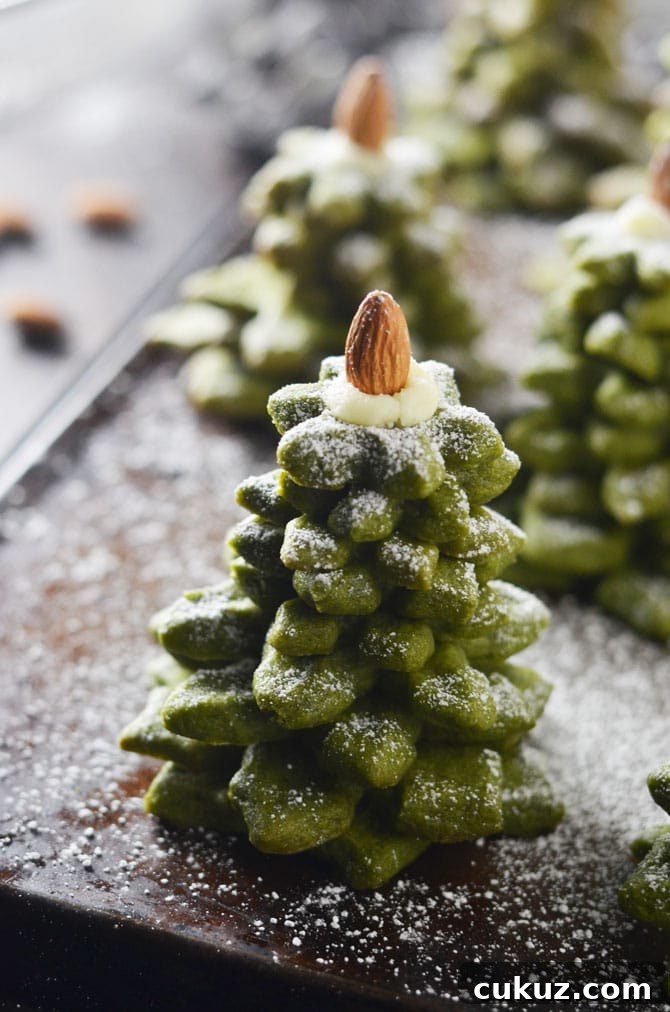 Matcha Cookie Christmas Tree Stacks. Buttery, sugary matcha green tea cookies make delicious Christmas gifts. Stack 'em up, sprinkle with powdered sugar, place an almond on top, and wrap them up in cellophane before passing them out as presents. | hostthetoast.com