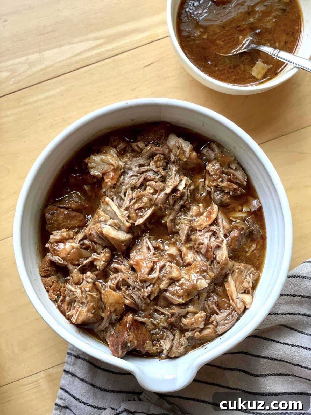 Instant Pot Country-Style Ribs with Tender, Fall-Off-the-Bone Results 7 A white bowl of instant pot country style ribs with a bowl of sauce.