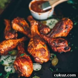 Smoked chicken drumsticks on a baking sheet.