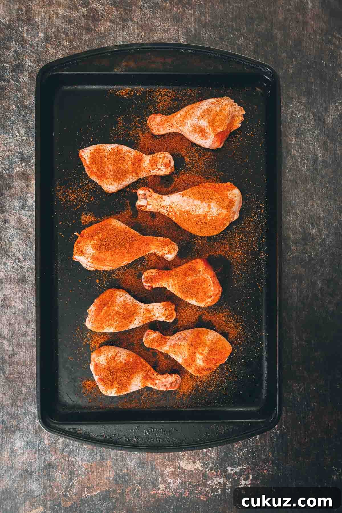 Chicken legs coated in spices.