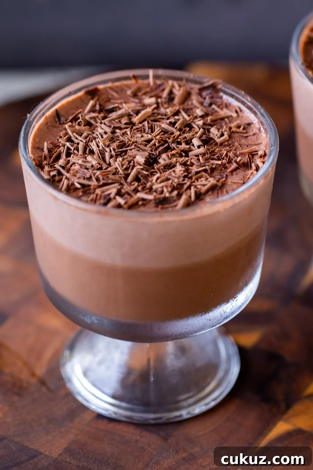 cup of two-layer vegan chocolate pudding with chocolate shavings on top