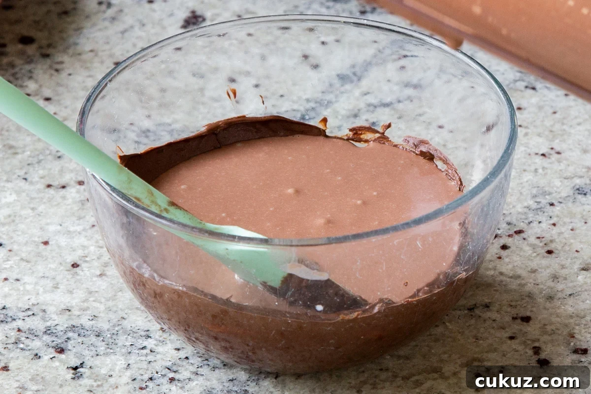 adding mousse to the melted chocolate chips