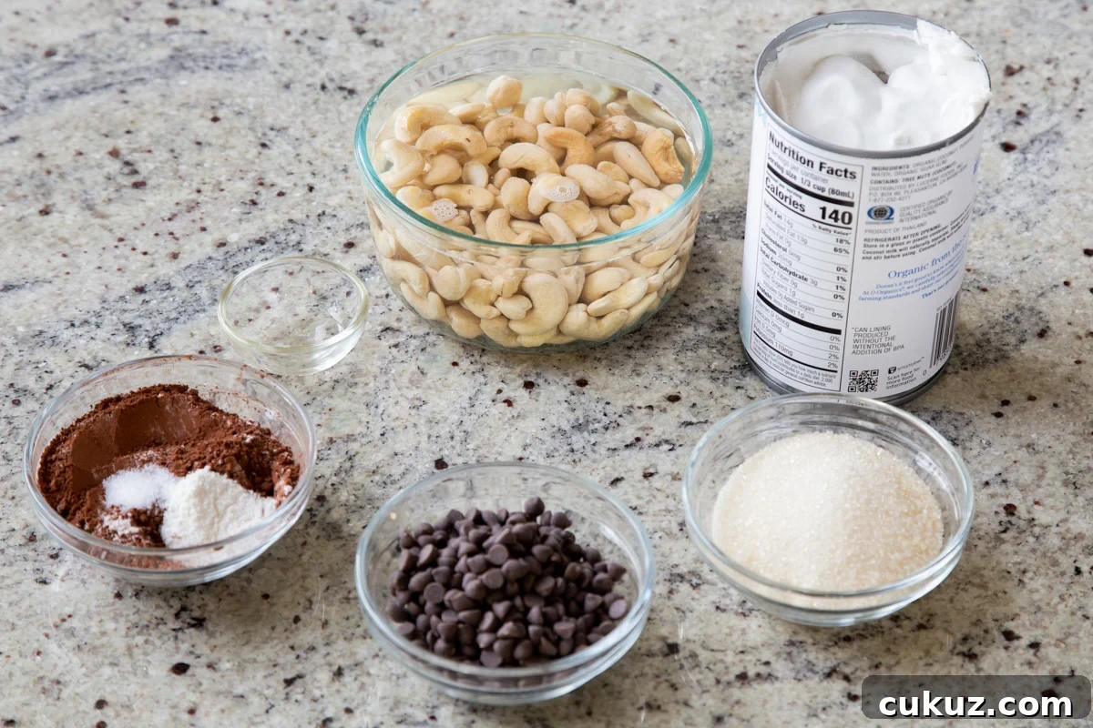 cashews, chocolate chips, and other pudding ingredients in bowls on a kitchen counter