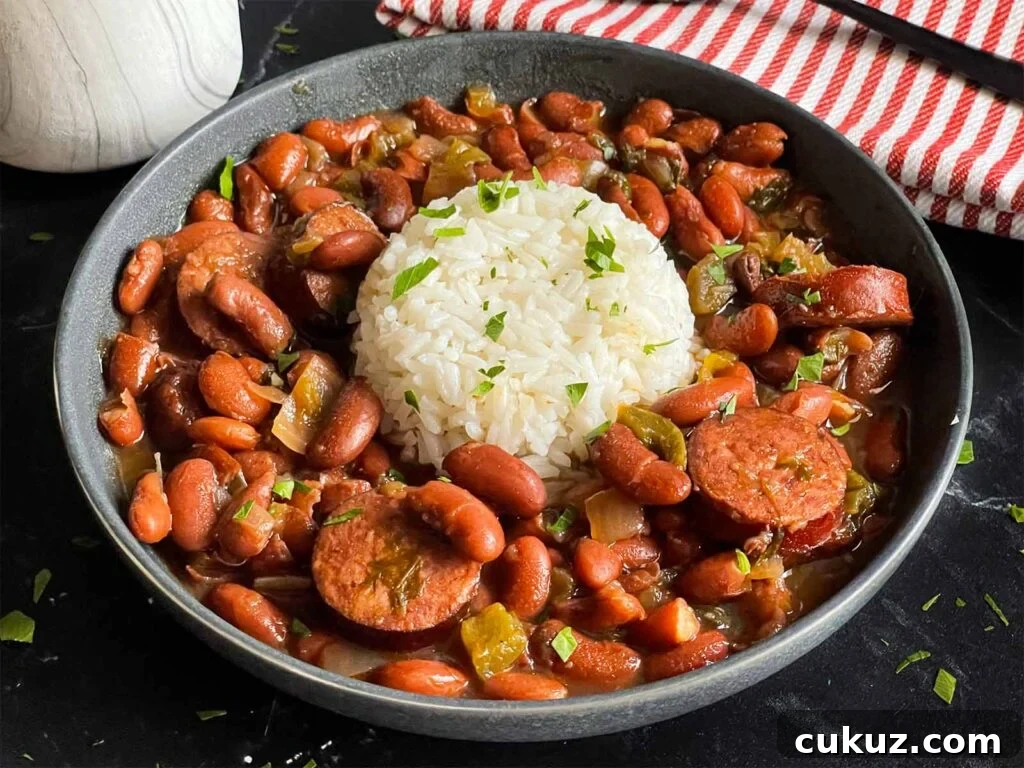 Slow cooker red beans and rice in a dark bowl on a dark surface.