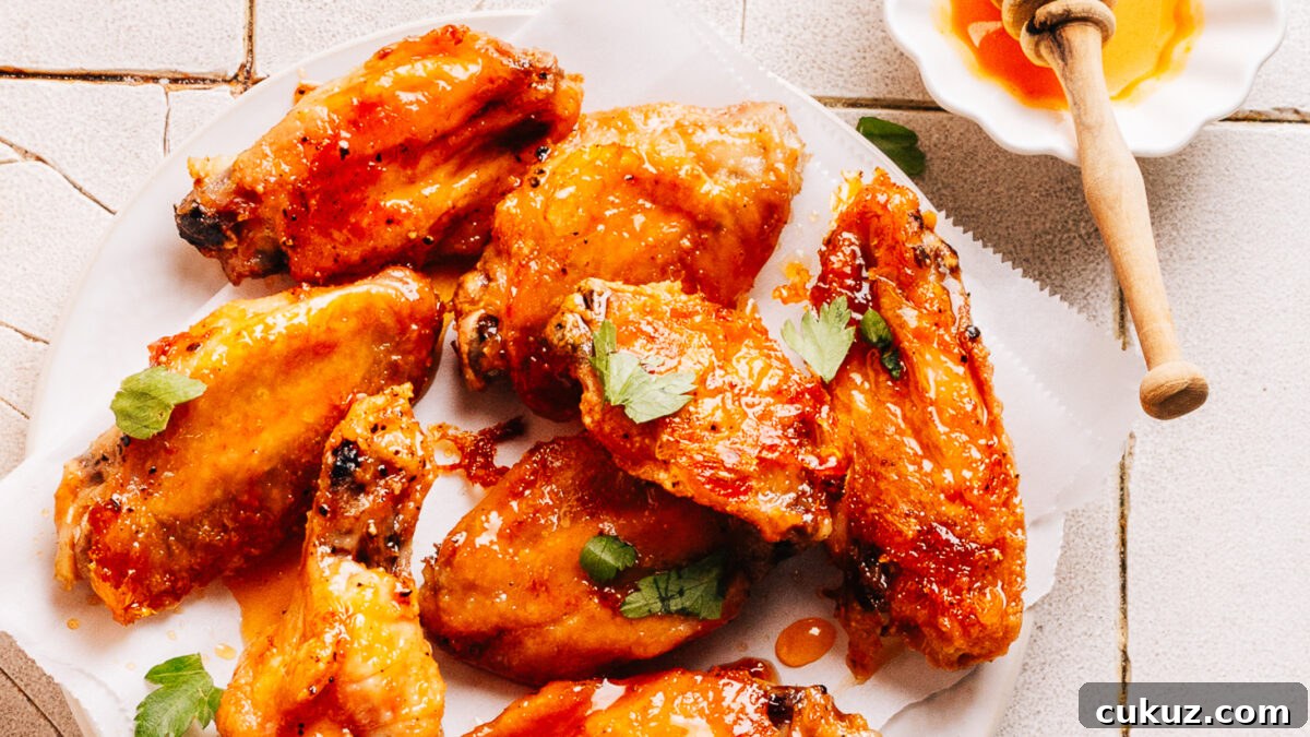 A plate of wings with hot honey sauce.