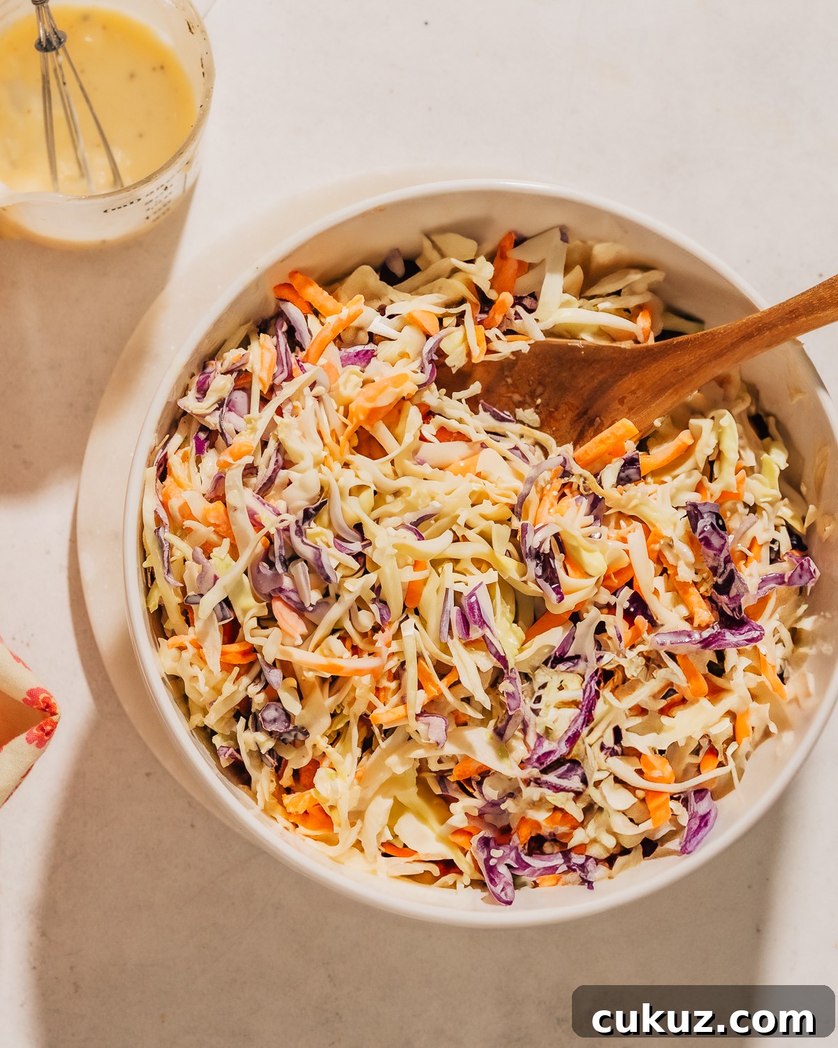 Easy Coleslaw recipe in a bowl with a spoon.