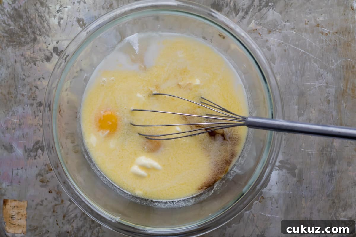 wet ingredients in a mixing bowl with a whisk