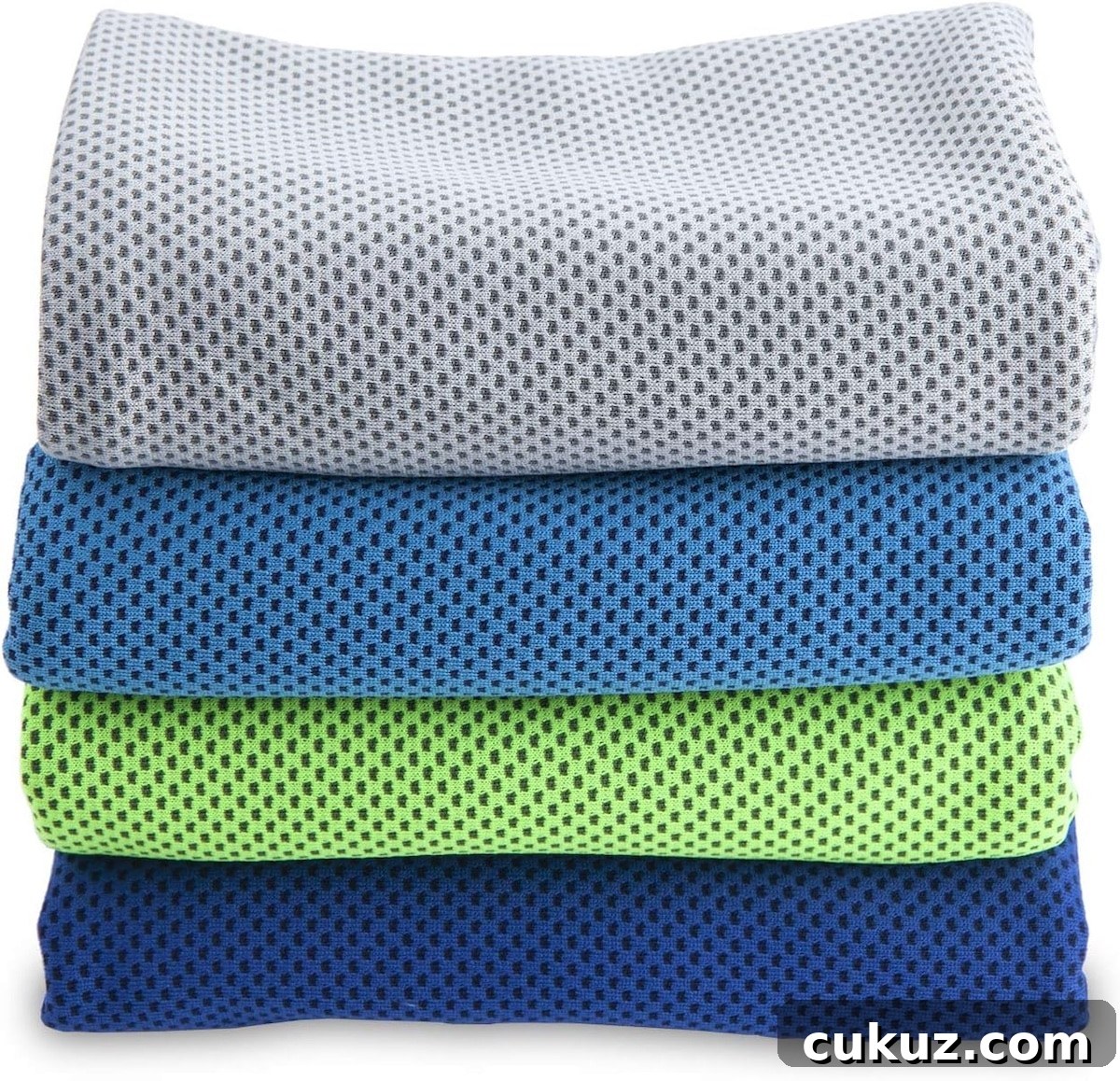 A stack of four folded towels in gray, blue, green, and dark blue—each with a small dotted pattern—brings fresh style reminiscent of an epic universe in July.