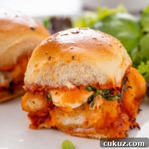 Close up of a chicken parmesan slider on a plate.
