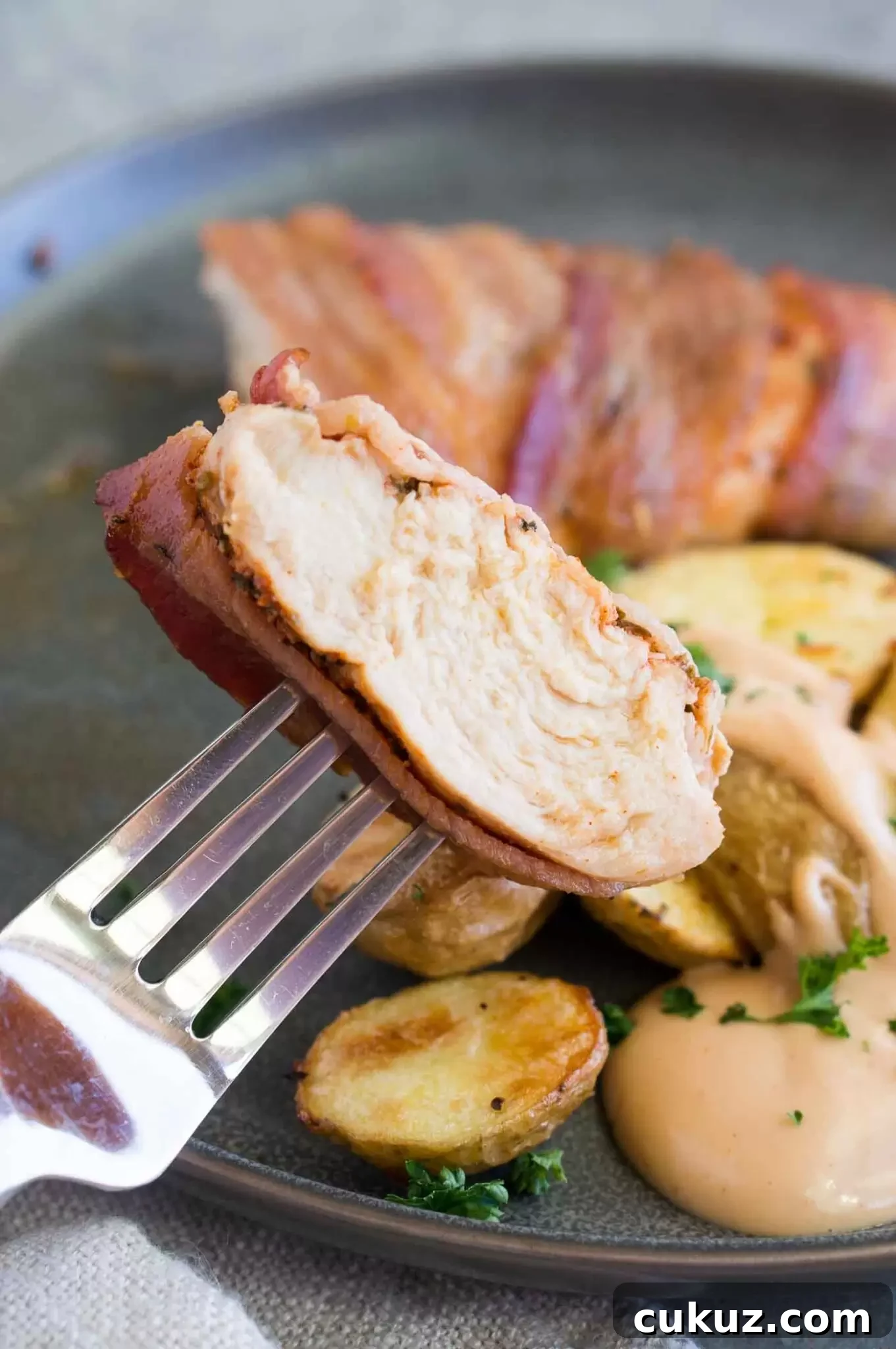 a bite of bacon wrapped chicken