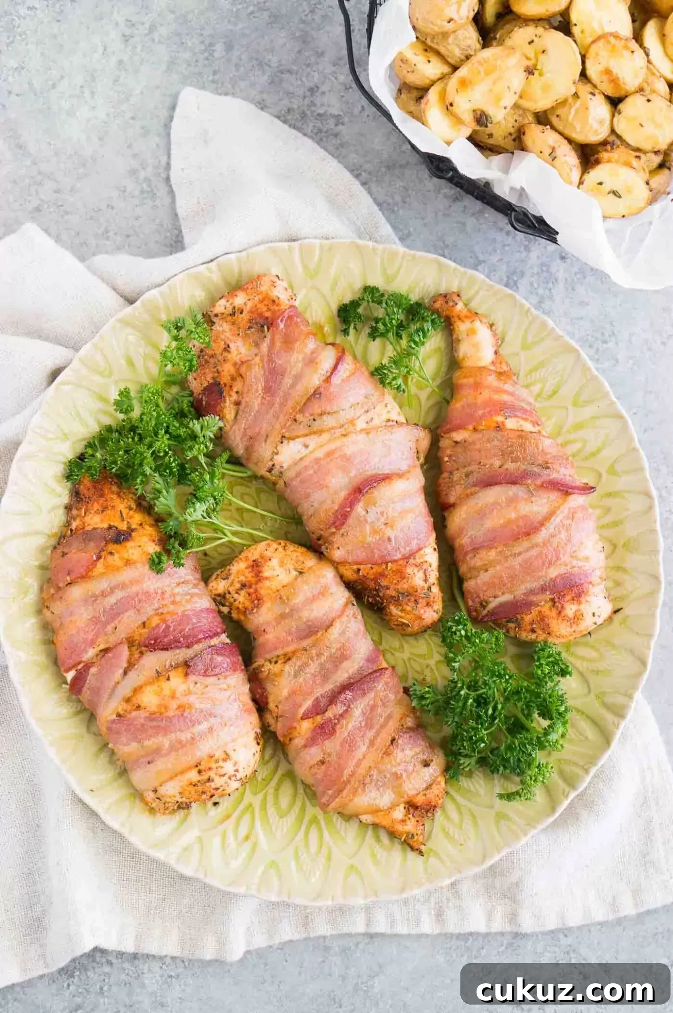 chicken breasts wrapped in bacon on a platter