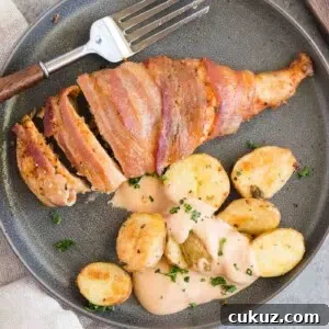 bacon wrapped chicken served with roasted potatoes