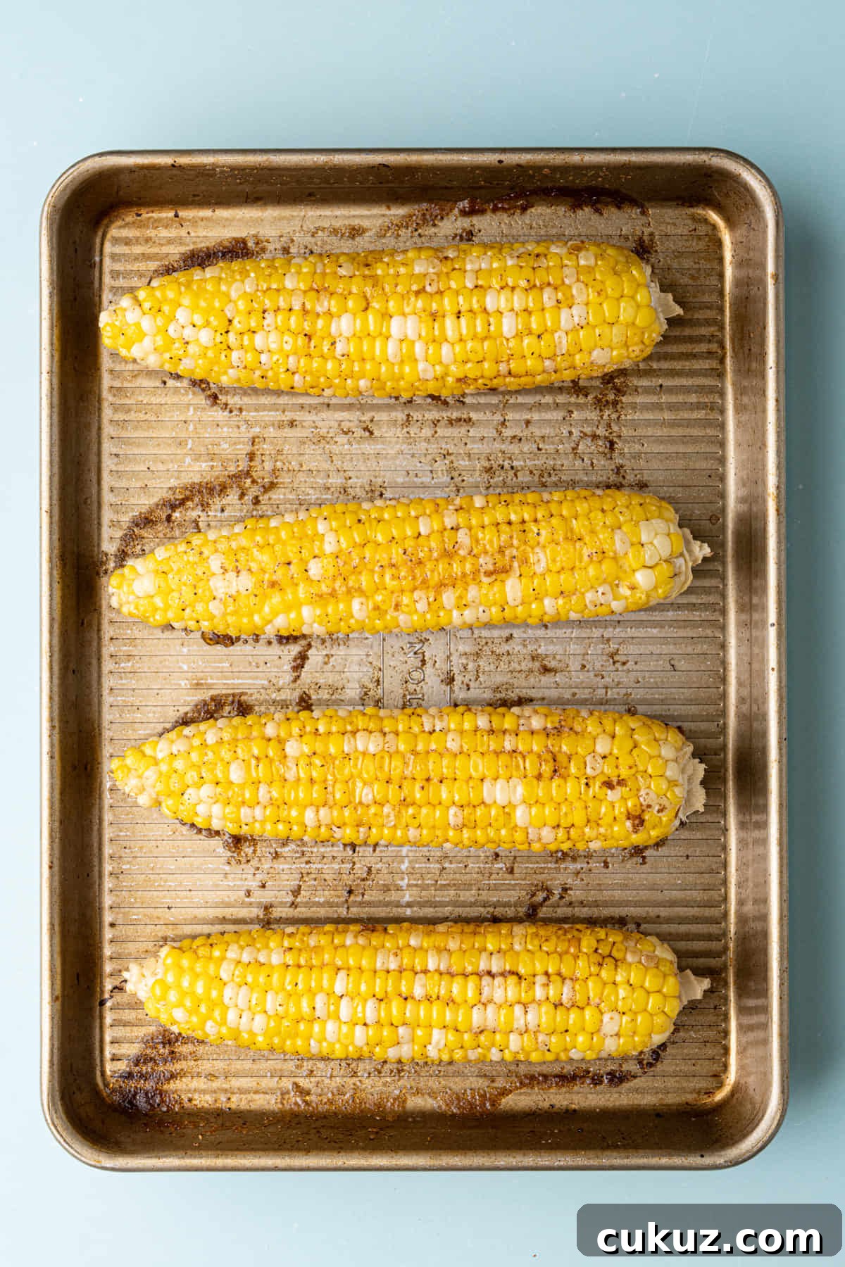 Cajun Roasted Corn on the Cob fresh out of the oven still on the baking tray.