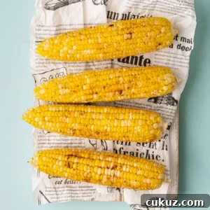 Overhead image of Cajun corn on the cob that's been roasted in the oven.