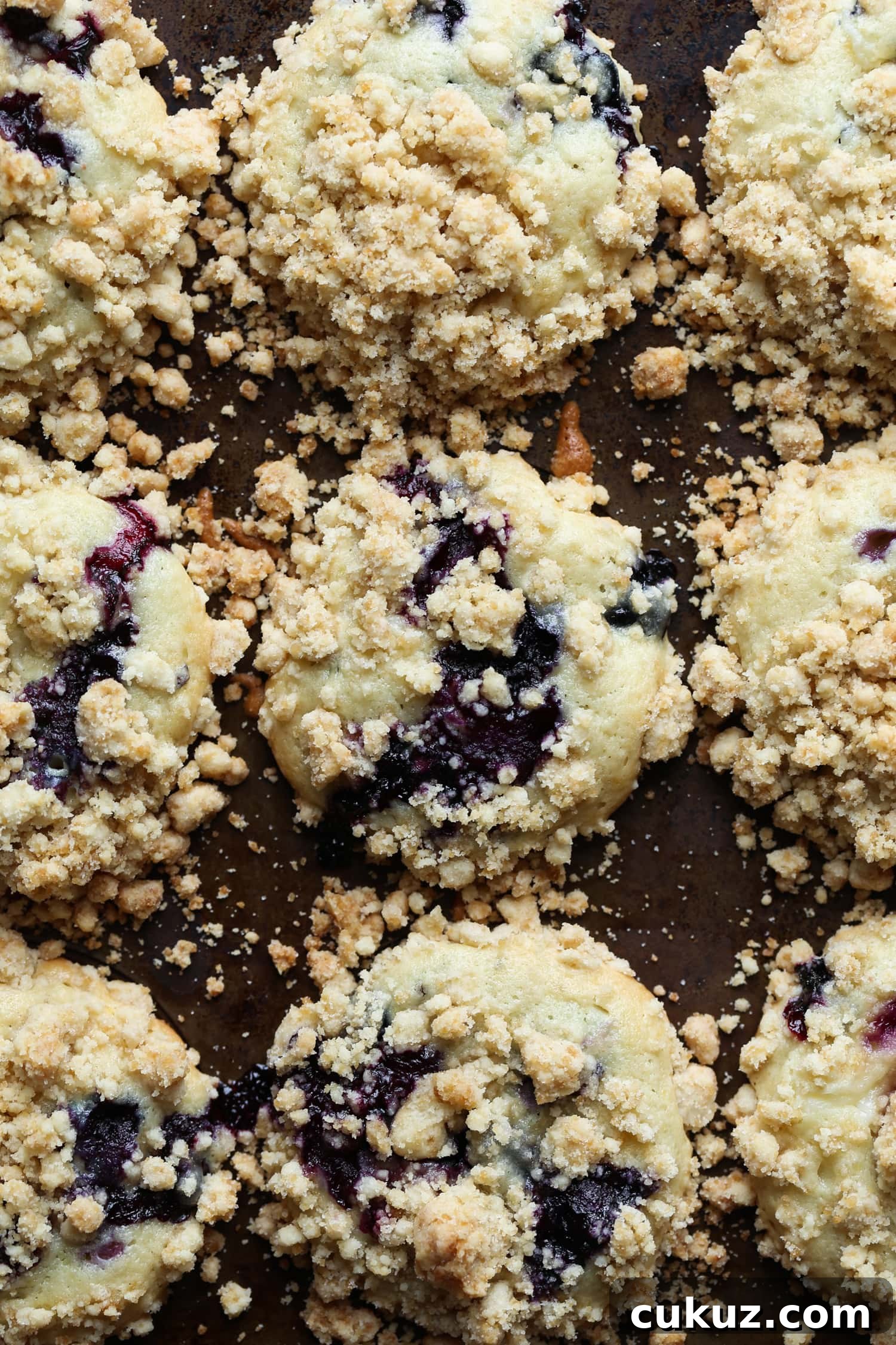 Overhead image of blueberry cream cheese muffins on a cooling rack.