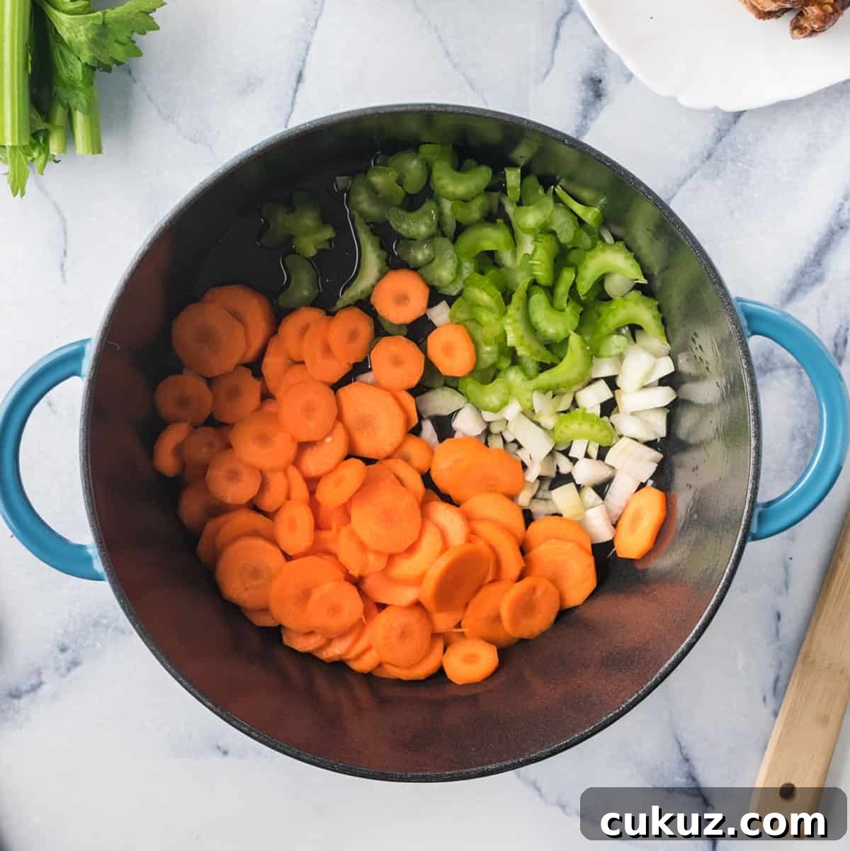 Rotisserie Chicken Noodle Soup Made with Lipton Broth 5 A pot of cut carrots, onion, and celery for a mire poix.