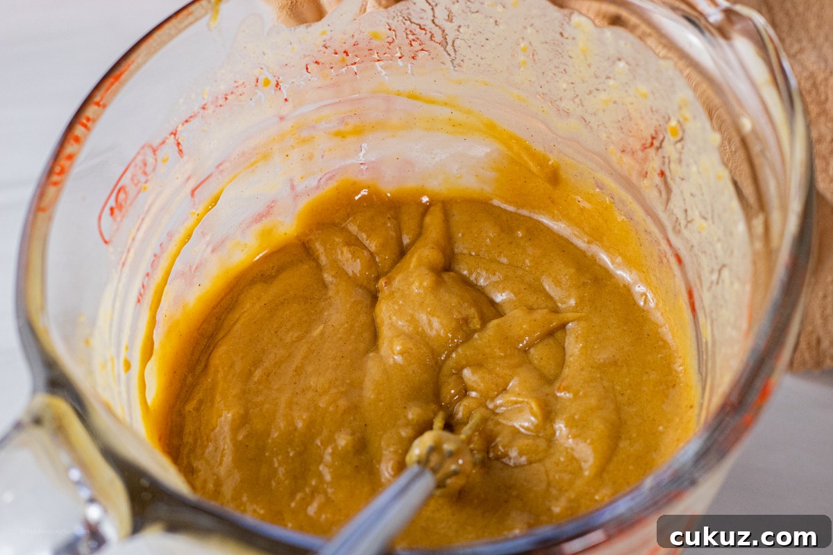 Creamy Peanut Dipping Sauce Recipe for Asian-Inspired Dishes 4 sauce made with peanut butter in a glass measuring cup
