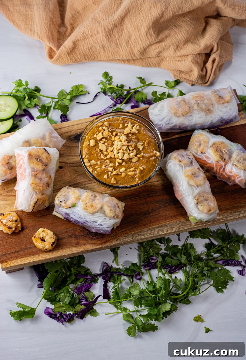 Creamy Peanut Dipping Sauce Recipe for Asian-Inspired Dishes 6 spring rolls surrounding a bowl of peanut sauce