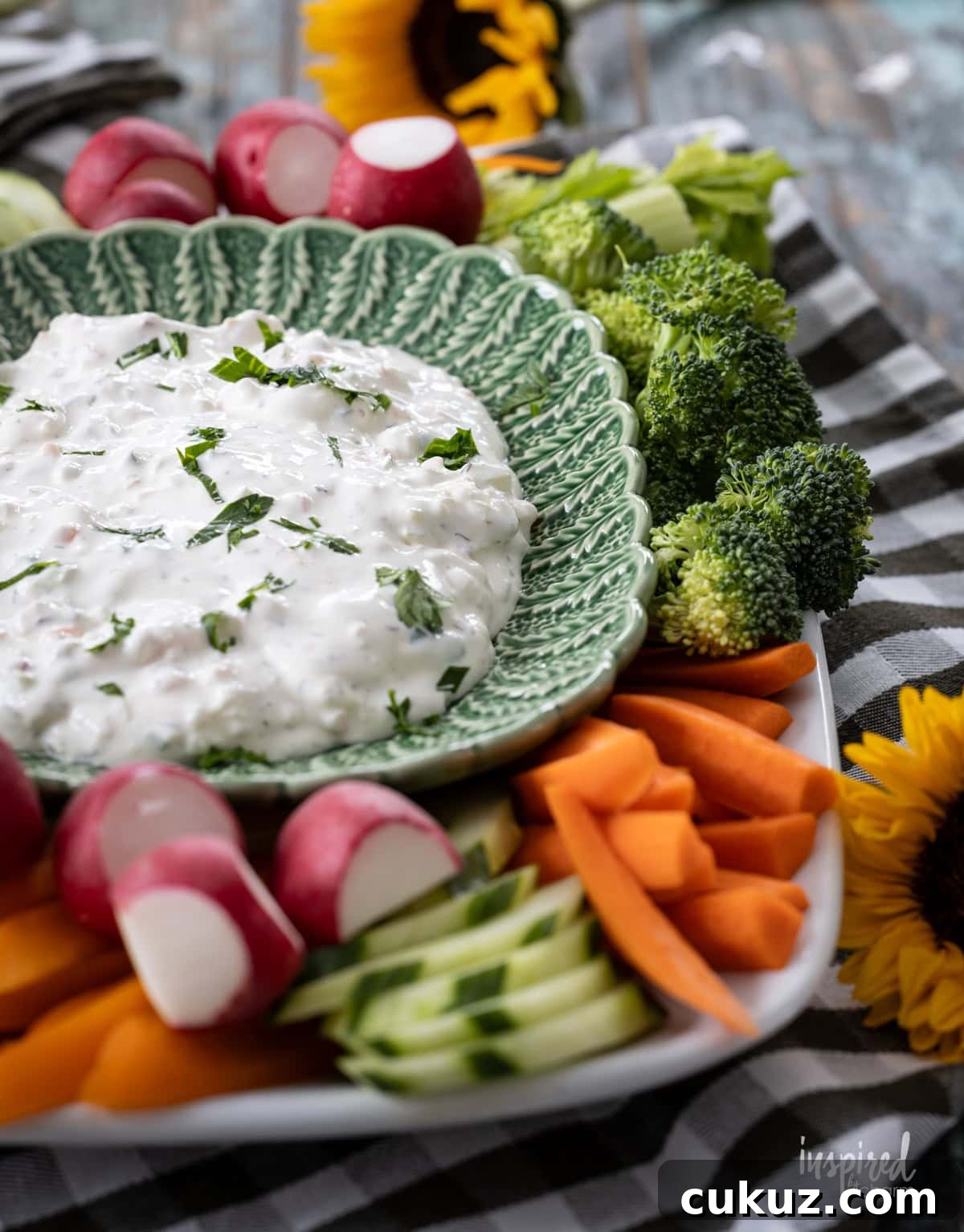 vegetables surrounding a bowl filled with creamy garden vegetable dip.