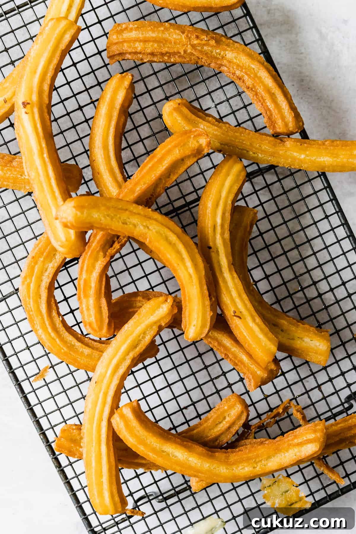 How to Make Crispy Homemade Churros with Chocolate Dipping Sauce 7 Sixteen Churros on a Wire Cooling Rack