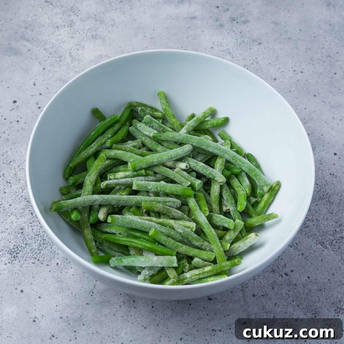 Photo showing a bowl of frozen green beans.
