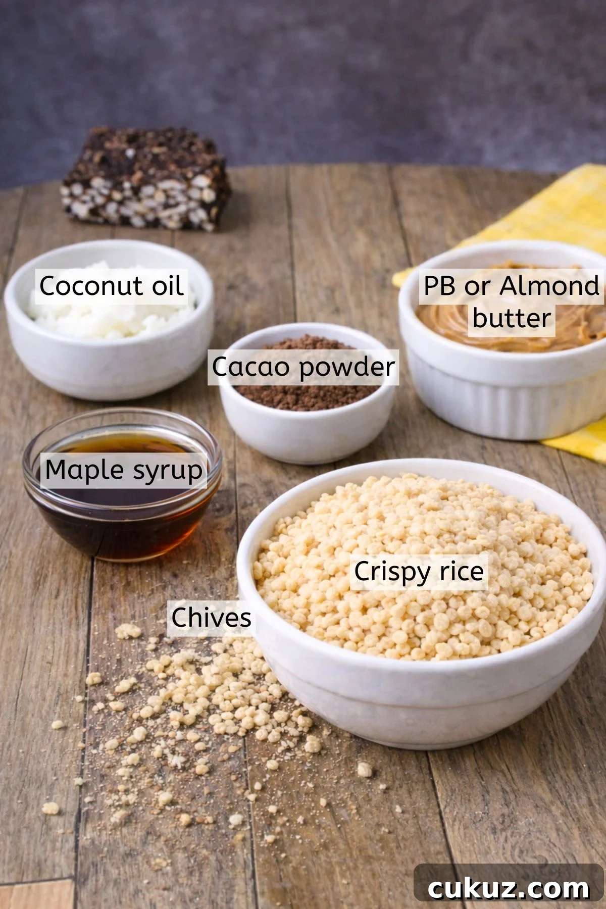 Crispy rice, cacao powder, maple syrup, peanut butter, and coconut oil in bowls with text labels over top.