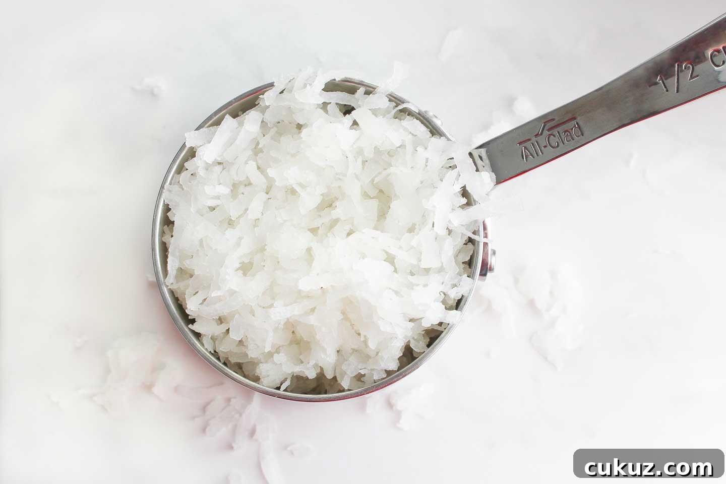 A measure of coconut flakes ready to be added to fudge.